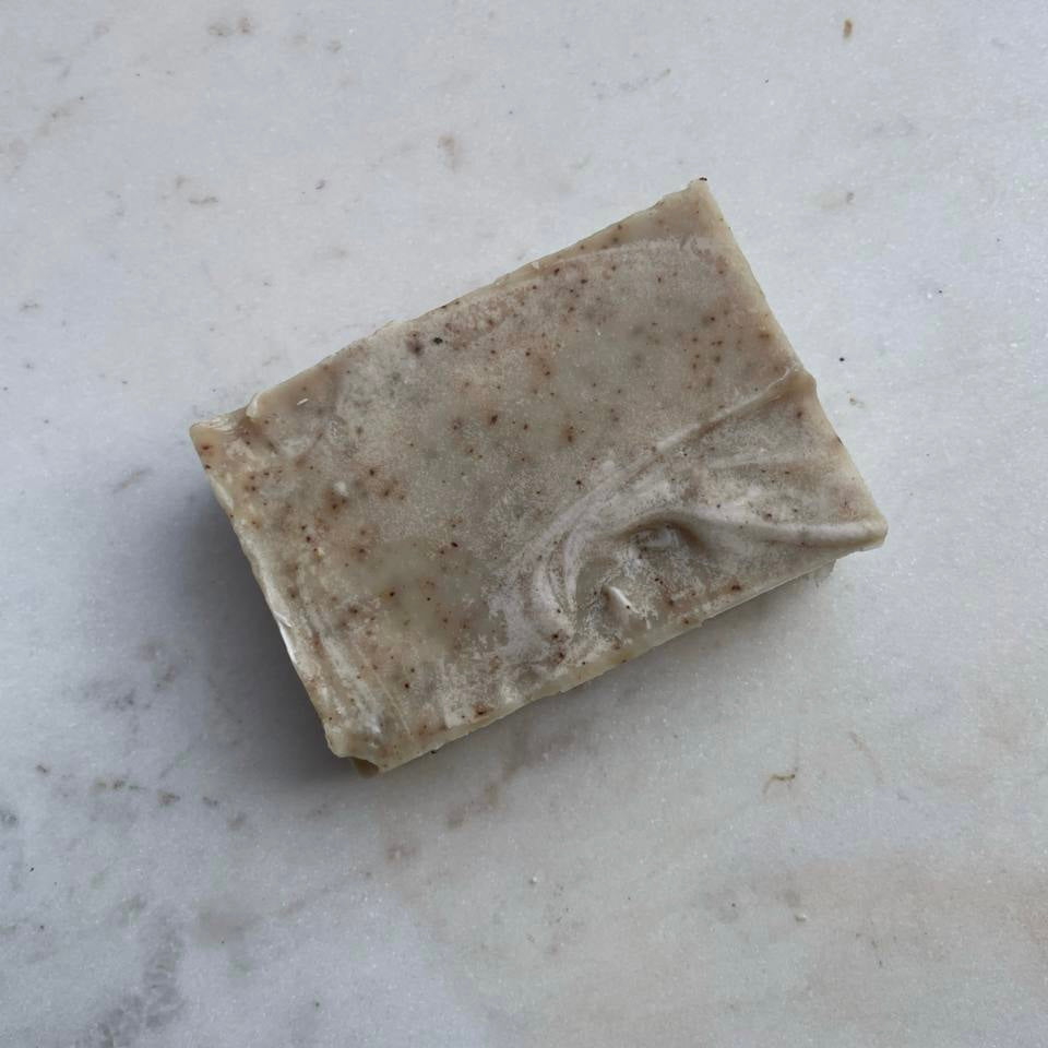 A single coffee exfoliating bar of soap on marble The Herbal Gardener