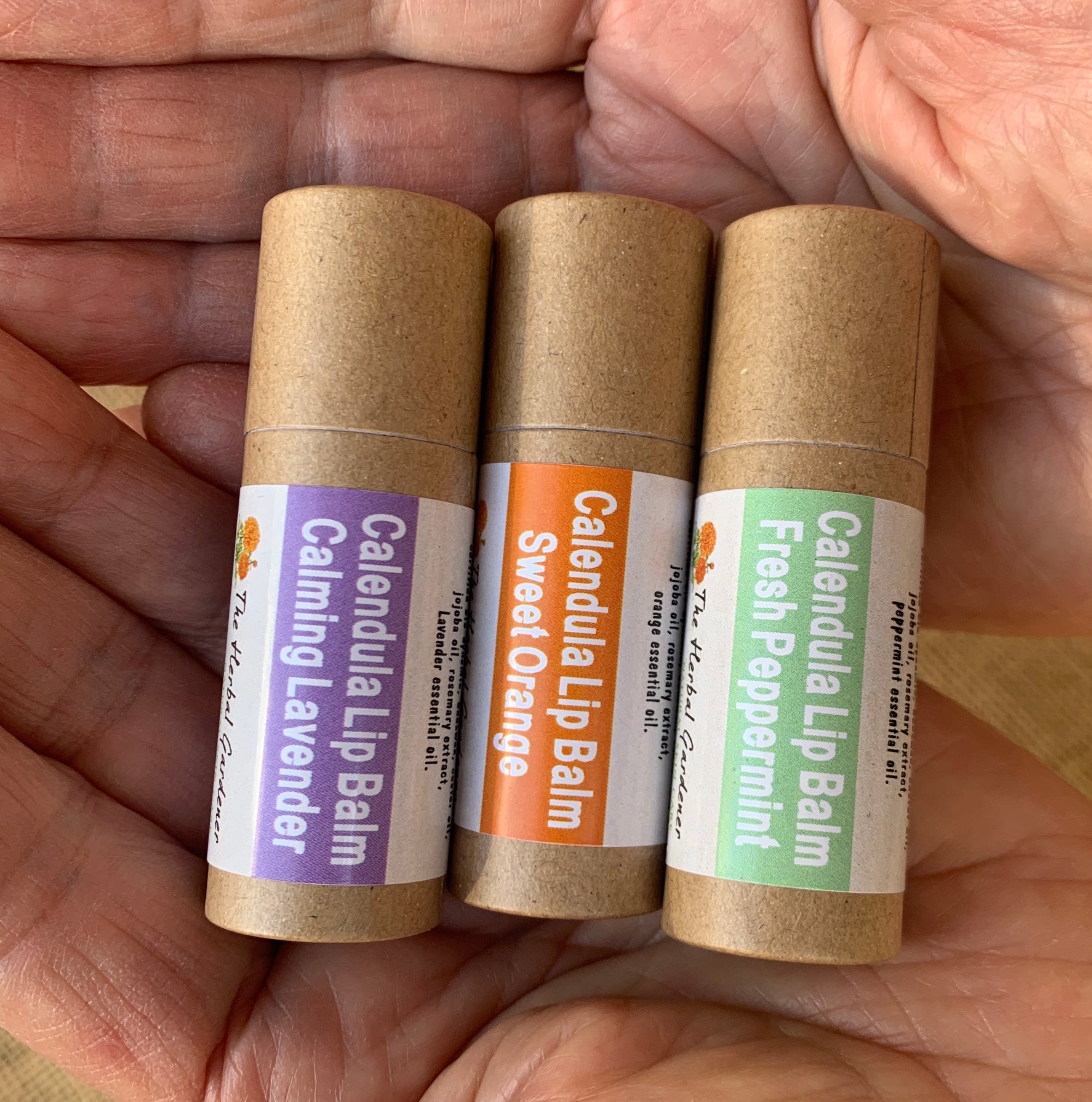 Three Calendula lip balms with three scents of calming lavender, sweet orange and fresh peppermint The Herbal Gardener