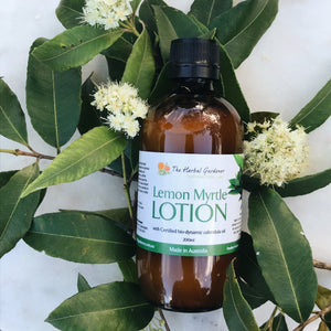Lemon Myrtle and Calendula Body Lotion 200mL bottle surrounded by lemon myrtle leaves and flowers The Herbal Gardener
