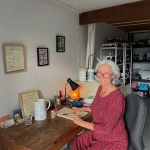 Lise Racine, founder of The Herbal Gardener sitting in her herbalist consultation space Tallebudgera