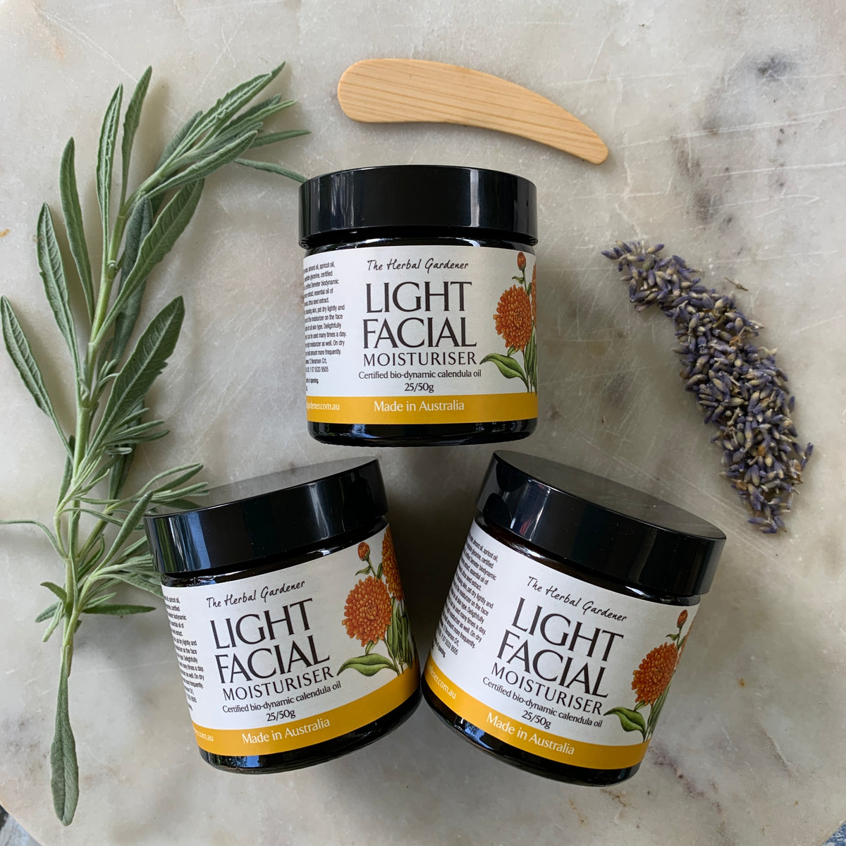 Calendula Light Facial Moisturiser Three Pack 50gr each with a wooden spoon, dried lavender The Herbal Gardener