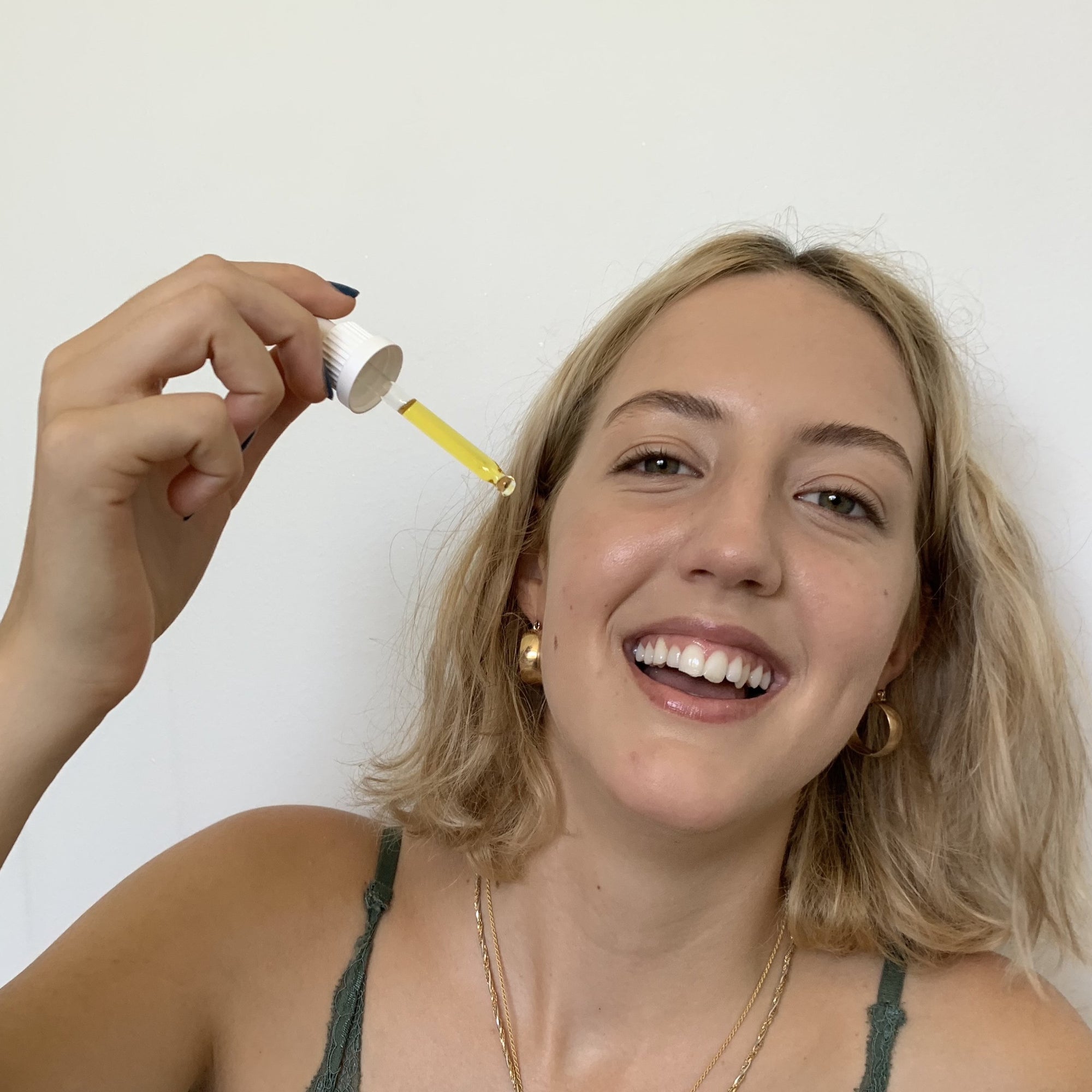 Calendula Oil in dropper with model The Herbal Gardener