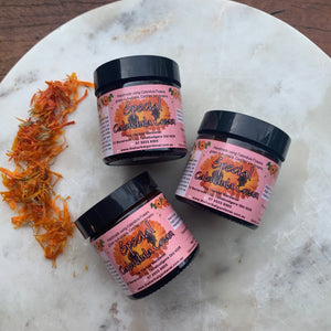 Special Calendula Moisturiser 50gr Three Pack on a marble and wooden background with dried calendula flowers