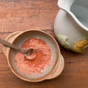 Pink Clay Face Mask in a bowl with water The Herbal Gardener